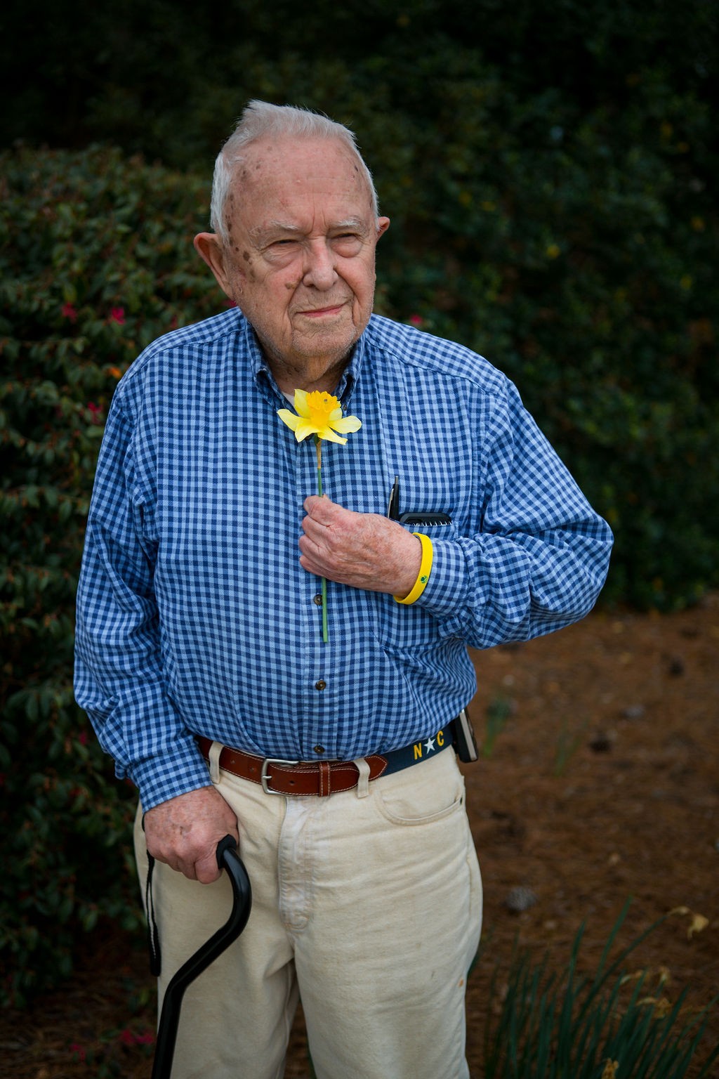 Old man with daffodil blossom
